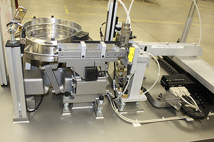 Feeder system with X-Y table loads tiny parts into matrix tray